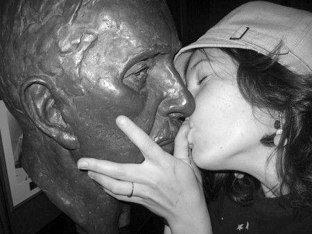 Emily Horn kissing a statue in the Supreme Court of Canada