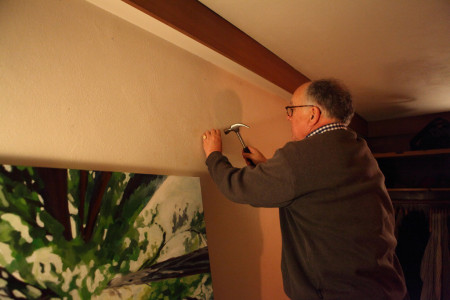 Master John Fraser hanging a painting